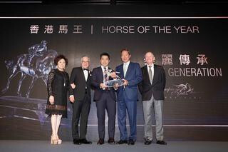 Beauty Generation is crowned Horse of the Year. Dr. Simon S O Ip, Chairman of HKJC, presents the trophy to owner Mr. Patrick Kwok Ho Chuen, accompanied by Dr. Simon Kwok, Dr. Eleanor Kwok and trainer John Moore